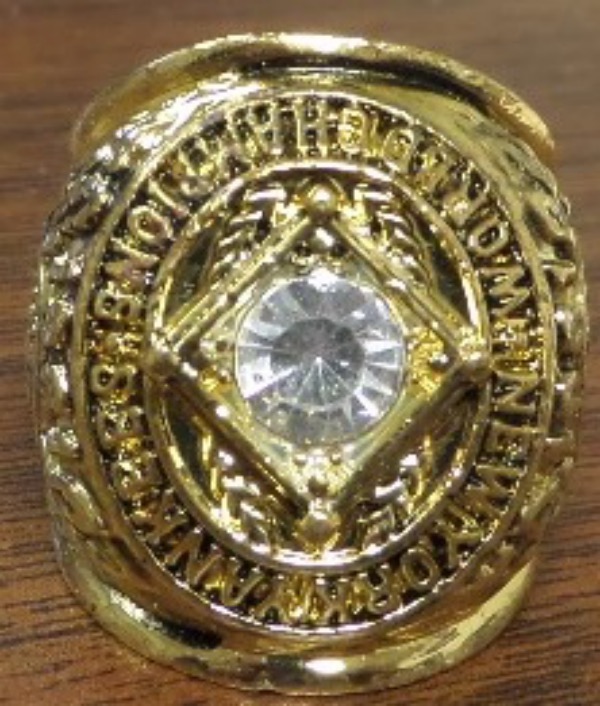 This gold plated ring from the World Champions NY Yankees in 1961 and has lots of black printing on it, a huge, brilliant CZ diamond sits atop the front, and is engraved on both shanks with team logos from this World Championship YANKEE Team. Nice look, a super display ring, exact replica of the real deal the players received, except for Diamonds, and a rare one that you just never see for sale from this "Magical year of the Yankees", and Maris/Mantle's movie, and MARIS 61 Homerun year. Great look, value is HIGH on this beauty, and a real must have for all YANKEE rooters. 