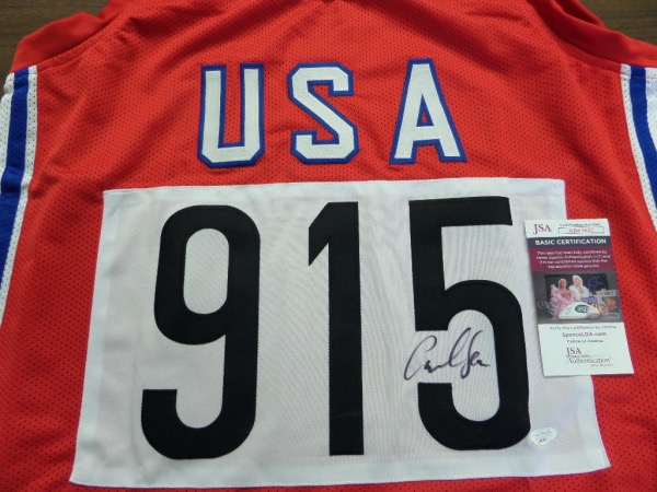 This superb Olympic item is a custom made, patriotic, red, white and blue jersey, and with his winning number sewn on. It is a must have item from the gold medal winner, comes boldly, perfectly black marker signed, and grades a 10 all over. Add in the JSA lifetime authenticity and you have an easy choice to make.   