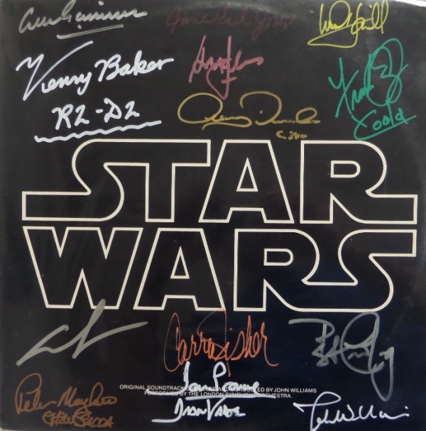 This 1977 original soundtrack LP album for the megahit "Star Wars" is still in EX/MT condition.  It is hand-signed in various bright colors by no less than 14 stars of the insanely popular film franchise, including Guinness, Baker, Jones, Hamill, Ford, Daniels, Oz, Lucas, Mayhew, Fisher, Prowse, Cushing and John Williams.  With 5 of these icons now deceased, this beautiful and colorful album is valued at PRICELESS!