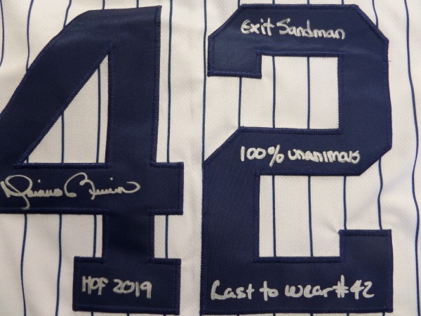 This home white, pinstriped size 44 NY Yanks jersey from Nike is still tagged as new, and comes to us with everything sewn.  It is back number-signed in bright silver by the greatest closer EVER, complete with the following inscriptions:  HOF 2019, Exit Sandman, 1st unanimous HOF'er, and Last to wear #42.  A fantastic NYY item, valued into the mid/high hundreds, especially with these cool inscriptions added!