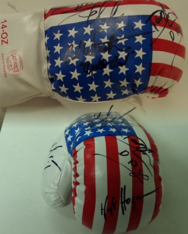 This unique item is a mint USA flag 14 oz. boxing glove that comes signed wonderfully in black sharpie by 5 stars from the legendary Rocky movie and sequels. Included are Sylvester Stallone and 4 of his opponents over the years. Included are Carl Weathers, Mr.T, Dolph Lundgren, & Hulk Hogan!!  A MUST for the boxing fan and even some of their character names included by the legends!
