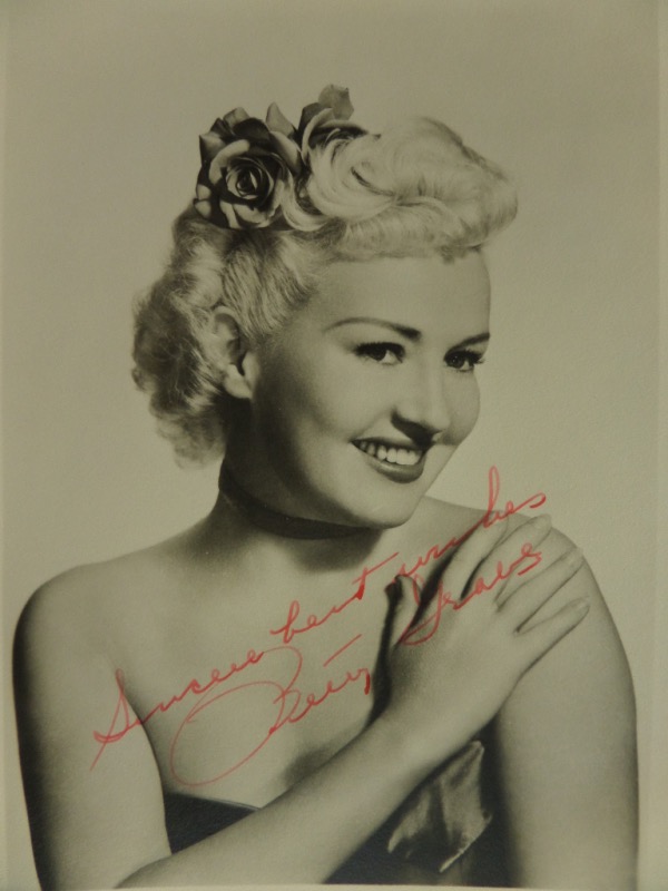 This very old 5x7 photo is a black and white image of 1940's Hollywood icon, Betty Grable. It is in EX/MT condition, and comes hand-signed in RED by the star herself.  Signature grades a legible 8, with Sincere Best Wishes added as an inscription, and with Grable deceased now just short of a half century, retail is well into the hundreds!