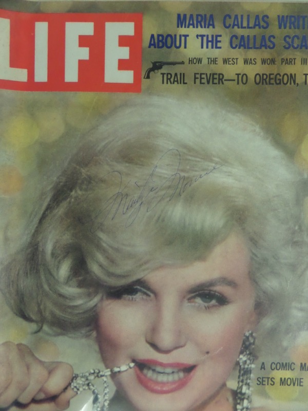 This impressive, must have Hollywood investment item is a vintage, color covered full issue of Life magazine and shows the starlette on the cover. It is in EX/MT condition overall, comes cover signed by Monroe in her ornate blue ink style and grades an honest, clean 7 or so overall. It can be viewed with ease from 12 feet away and would be valued near $2500.00 since her suspicious death in 1962. Great item to have matted, framed and forever, shown off proudly. 