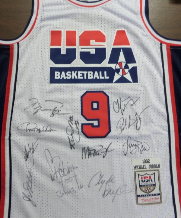 This white size 50 Mitchell & Ness #9 USA Basketball Michael Jordan jersey is in NM/MT condition, with everything sewn, and comes front signed in black sharpie by by all 12 members of the original Dream Team!  Included are Bird, Magic, Jordan, Barkley, Ewing, Drexler, Robinson, Malone, Stockton, Pippen, Laettner and Mullin, and this AWESOME and one of a kind display item books well into the low thousands!