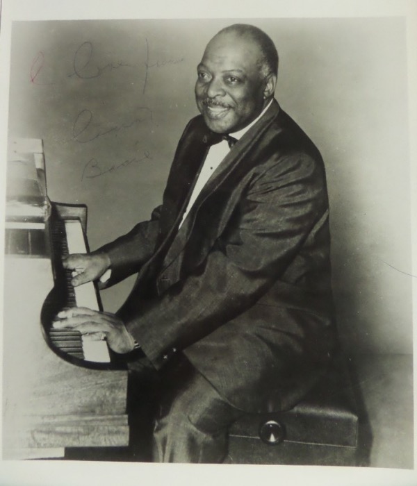 This black and white 8x10 photo shows jazz legend Count Basie playing the piano  It is hand-signed in black ink by the big band leader and musical icon himself, grading a faded but still legible 5, and including a Love From inscription.  With Basie's death now just short of 4 decades ago, retail on this photo is well into the mid/high hundreds!