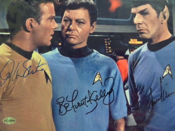 This high value color 8x10 is circa 1967 and shows 3 men aboard the Starship Enterprise from the sci-fi hit TV series. It comes hand signed by William Shatner, DeForrest Kelly and Leonard Nimoy. Gerade is a bold 9-10 all over, and a sought after SCM lifetime COA and matching hologram are intact. Wow!!
