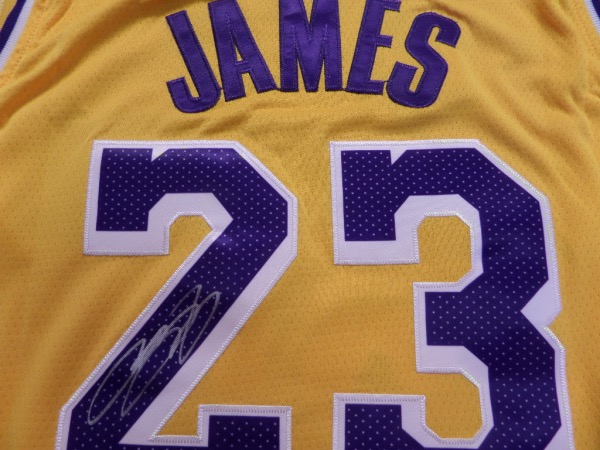 This yellow size 50 LA Lakers jersey from Nike is still tagged as new, and comes trimmed in purple and white, with everything sewn.  It is back number-signed beautifully in bright silver by King James himself, the signature grading a legible 9, and including his number 23.  Ideal for framing and display and retail is low thousands!