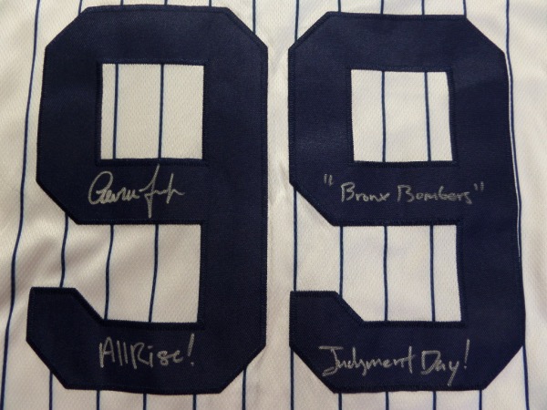 This home white, pinstriped size 44 Yanks jersey from Nike is tagged as new, and comes trimmed in navy, with everything sewn.  It is back number-signed in silver by the All Star outfielder himself, grading an overall 8, with "Bronx Bombers", Judgement Day! and All Rise!  inscriptions.  A MUST for the true Yankee collector, and retail is high hundreds!