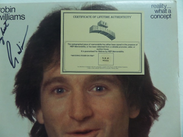 This original 1979 "Reality ... What a Concept" LP album from Robin Williams features a large, close up image of the comic on the front, and is hand-signed in black sharpie by the man himself.  The signature grades about an 8 overall, with an All My Best inscription, and the autograph comes certified by N.E.P. Memorabilia for authenticity purposes.  With his untimely death now approaching a decade ago, retail is high hundreds!
