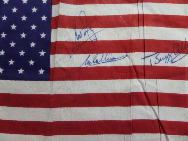 This mini American Flag is in EX condition and measures about 8x12 in size.  It is hand signed in blue by all three moon landing members of the Apollo 11 NASA mission, including Neil Armstrong, Michael Collins and Buzz Aldrin.  Signatures grade 7.5's-8's each, and this baby will show off beautifully upon display.  Valued well into the hundreds!