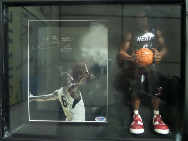 This roughly 12x14 black-framed, almost shadow box like display is still in EX overall condition, and is ready for your collection.  It features a LeBron James Miami Heat posable figure, and a color photo, hand-signed in silver by the 2 time Miami Heat world champ himself.  Comes fully PSA/DNA certified (M96739) for authenticity, and retail is very high hundreds!