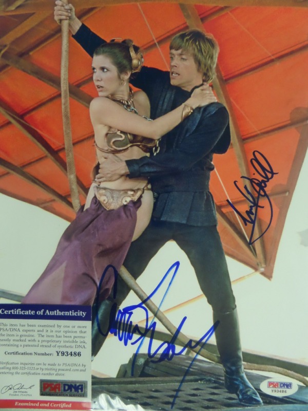 This AWESOME "Star Wars" collector's item is a full color 8.5x11 photo of Luke Skywalker and Princess Leia escaping Jaba the Hut's barge in the 1983 hit, "Return of the Jedi."  It is hand-signed by both iconic actors in blue sharpie, and the photo includes a COA from PSA/DNA (Y93486) for authenticity purposes.  Valued well into the mid/high hundreds, especially since Fisher's 2016 untimely death!