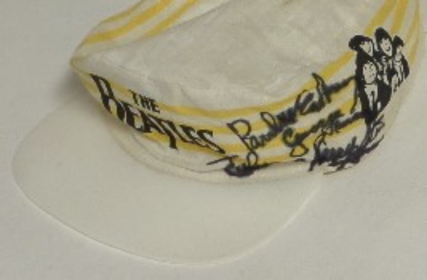 This very old "The Beatles" painter's style cap shows its age a bit, with light staining, but is still in EX shape overall, with the band logo in the front, and an image of The Fab Four on the side.  It is hand-signed in black sharpie by all four Beatles, and though the signatures bleed slightly against the material, they still grade 6's-7's each.  A truly unique Beatle item, and one valued into the low thousands!