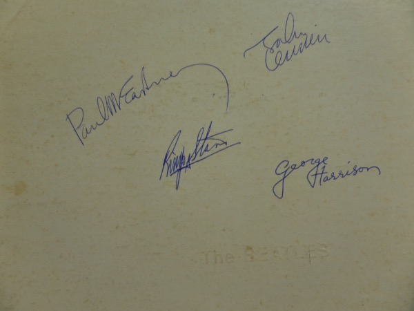 This amazingly unique collector's item is the classic 1968 Beatles "White Album," in VG/VG+ shape, and still completely intact.  It is hand-signed in blue ink by the entire band, on the front cover AND on the inside--please see our attached photo--for a grand total of 8 Beatle signatures!  Most here grade 8.5's or better.  Any album signed by all four these days is worth a small fortune.  This one?  I would think even more!