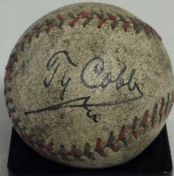 This vintage, red and blue-laced baseball is in G+ overall condition, and all markings have been rubbed away through some serious aging.  It features the top panel signature of the great 1936 HOF Inductee and all time batting average king, Ty Cobb, his black ink signature grading a sttrong 7, at least.  A great, vintage look and a ball that easily values into the thousands, especially with such a beautiful autograph evident!