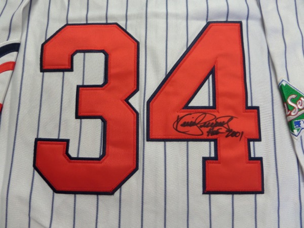 This throwback Twins jersey is pinstriped, a size L from Mitchell & Ness, that comes with everything sewn, including letters, numbers, and a 1991 World Series patch.  It comes back number-signed in black sharpie by the HOF centerfielder himself, grading a 7 overall, with HOF 2001 included in the signature.  With his death only 5 years after his induction, retail is low thousands!