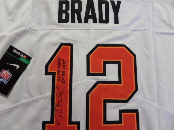 This white size L Tampa Bay Bucs #12 Tom Brady jersey is from Nike, and comes to us in NM/MT condition.  It has everything sewn, and is back number-signed in black by the future HOF passer himself.  The signature is a nice 8 at least, complete with 7X SB Champ and 5X SB MVP inscriptions, and retail right now is THOUSANDS on this jewel!