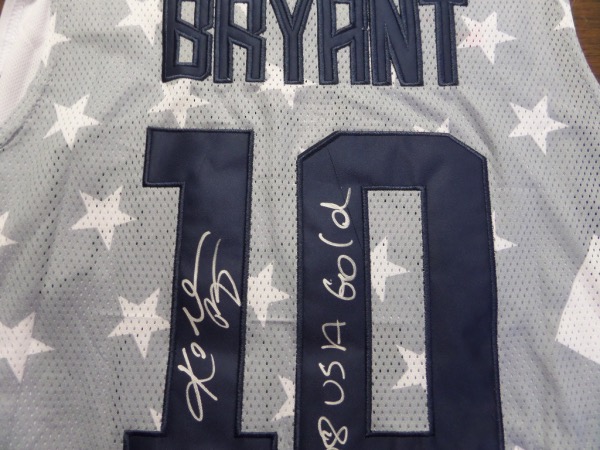 This Bryant #10 multi colored USA Basketball jersey from Nike is like NEW, a size L, with everything sewn.  it is back number-signed in bright silver by Kobe himself, a RARE full name signature that grades a clean 9 at least, with an 08 USA Gold inscription added.  With Kobe's tragic and untimely 2020 passing, this jersey is valued well into the low thousands!