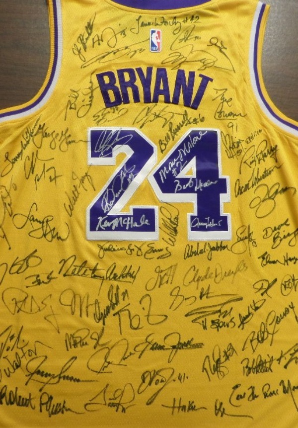 This yellow size 50 Kobe Bryant #24 Los Angeles Lakers jersey from Nike is still in NM/MT condition, and comes with everything sewn in purple and white.  It is back-signed all over in silver and black by SIXTY-THREE members of the now-famed 75th Anniversary team.  Included are Jordan, Russell, LeBron, Moses, West, Robertson, Bird, Frazier, Shaq, Barkley, Gervin, Walton, Erving, Cousy, Duncan, Robinson, Monroe, Magic, Pippen, Reed, Jabbar, Curry, Barry, Drexler, Olajuwon, Pettit, Stockton, Malone and so many more.  Check out our photo, and then, bid accordingly!!!