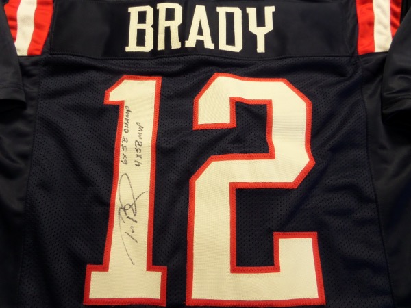 This New England road blue is trimmed in red and white team colors, has sewn on everything as well as name on back, and comes back #12 signed by the GOAT. It grades a clean strong 9 on the HOF signature, some other added stats are written as a bonus, and value is thousands on the now impossible signature to obtain. 