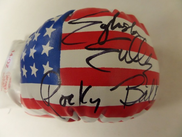 This 14 ounce USA flag-style glove has laces and is mint! It comes signed perfectly by this aging legend in black with his character name "Rocky Balboa" included!  Perfect for display and retails in the high hundreds/low thousands. Guaranteed authentic. 