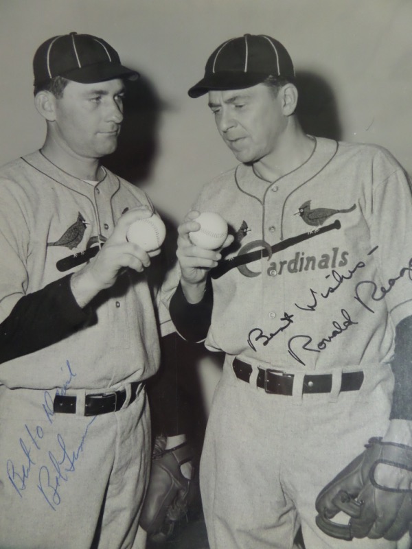 This black and white 7x9 photo is an original 1952 wire photo, and shows actual MLB HOF pitcher Bob Lemon and future President Ronald Reagan, playing Cardinals HOF pitchers Jesse Haines and Grover Alexander. . It is hand-signed in black by Reagan and in blue by Lemon, and with both men now deceased, this one of a kind photo is valued at ... PRICELESS!