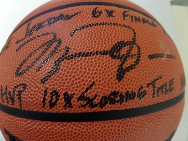 This Authentic Series basketball from Wilson is in MINT condition, and comes hand-signed in bold black sharpie by NBA All Time Great, Michael Jordan.  The signature grades a clean, legible 8 at least, including Air Jordan, 6X Finals MVP, 5X MVP, 10X Scoring Title, and HOF 2009 inscriptions, and the ball is valued into the very high hundreds!