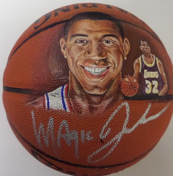 This special NBA HOF display is a rare one of a kind, hand painted by a talented artist, and comes boldly silver paint pen signed as well by Magic. The painting and autograph are perfect, the other side of the ball has some light imperfections, and this work is dated by the sports artist from 1993. It is a beauty, and probably valued upwards of $1500.00. 