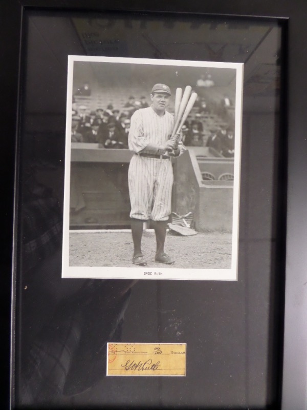 This 14x20 framed and matted display features a black and white photo of Babe Ruth holding three bats while waiting on deck in his home white NYY uniform.  Under the photo is a cut from an original check, hand-signed G.H. Ruth by the man himself, and grading an overall 7.5.  Ready for display, and valued well into the thousands!