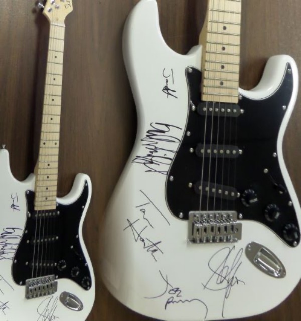 This mint white GORGEOUS electric guitar comes body signed by all five members of this iconic hard rock band!  Included are Hamilton, Kramer, Perry, Tyler and Whitford, all in bold black sharpies, and this baby will show off in Hard Rock Cafe style!  Valued into the low thousands+++ and comes with original carry case, bag, pick ups etc.. WOW Guaranteed authentic. 