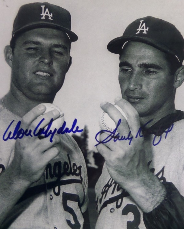 This black and white 8x10 photo shows Los Angeles Dodgers HOF ace hurlers Don Drysdale and Sandy Koufax, posing together with baseballs in their hands.  It is hand-signed in blue sharpie by both all time greats, and will frame and display beautifully for any collection.  Valued well into the hundreds!