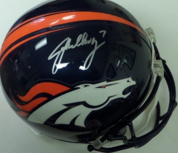 This mint condition, full size Denver Broncos replica style football helmet from Riddell comes hand signed by the 2 time Super Bowl Champion QB, John Elway!  The silver sharpie signature is a clean, legible 8.5, and this helmet is valued in the mid to high hundreds!