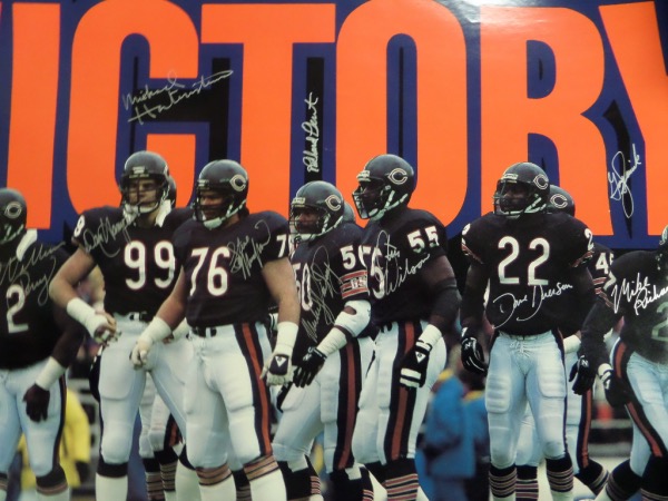 This "VICTORY" poster measures 19x27, is in EX/MT condition, and done in color; a fantastic image of the dominant '85 Bears D!  It comes hand-signed in bright silver by 10 members of the all time great defensive unit, including William Perry, Dan Hampton, Mike Hartenstine, Steve McMichael, Mike Singletary, Richard Dent, Otis Wilson, Dave Duerson (dec), Mike Richardson and Gary Fencik.  If you're a fan of this amazing team--or really, just a fan of the game of football-you simply MUST get in on this once in a lifetime chance!