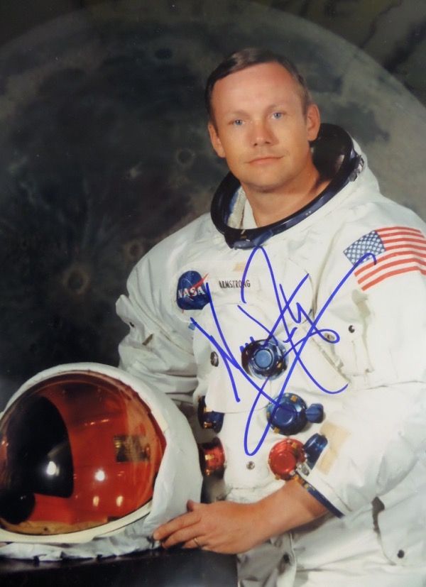 This full color 8x10 photo shows Neil Armstrong fully "suited up" and posing for the camera.  It comes blue sharpie signed by the deceased First Man On The Moon himself, the signature grading a gorgeous 9 overall, and with his passing, the photo is valued into the mid/high hundreds, at least!