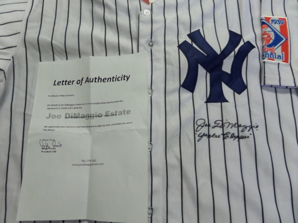 This mint, home white pinstripe jersey comes not only signed by Joe, but with his own estates LOA for certainty. The jersey is a gem features sewn on NY team logo as well as his #5 on back and the 1939 season patch on the sleeve. It comes front side signed in bold black marker, has his "Yankee Clipper" moniker written as a bonus, and value is sky high on this must have Bronx Bombers item.