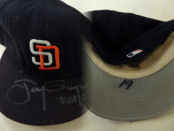 This fitted San Diego Padres cap from New Era is still in EX condition, with Gwynn's number 19 penned in black sharpie under the bill of the cap, suggesting that it was worn in an actual game by the HOF outfielder.  It is hand-signed by Gwynn on the top of the bill in silver, grading a 7, with HOF 07 added in his hand.  With Gwynn no longer with us, this unique collector's item is valued into the high hundreds/low thousands!