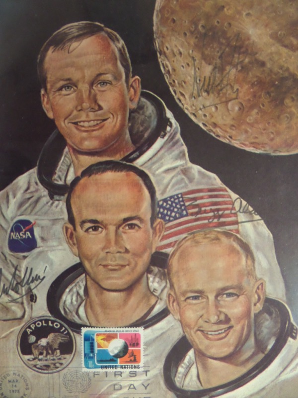 This high end "Great American" investment is a 1969-70 era color 8x10 print, and shows all 3 Men from the Moon. It comes dated, stamped and cancelled, comes black flair signed by Neil, Buzz and Michael, and grades an honest and faded 4 on the sought after signatures. terrific item still, and with 3 now impossible autographs.  