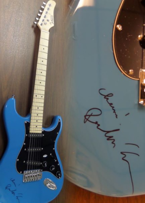 This gorgeous mint BLUE electric Glarry guitar comes with the original box, pick ups, bag, straps,etc. and comes signed by the best singer/songwriter of all time in black. SUPERB autograph and shows off wonderfully with "Cheers" included. Guaranteed authentic and get it now because Paul is a tough autograph and not getting any younger! 