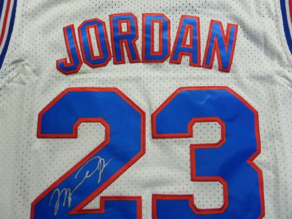 This white custom size L "Tune Squad" basketball jersey is in NM condition with everything sewn, and comes back number-signed in silver sharpie by "His Airness" himself, the great Michael Jordan.  This is a strong signature, grading a legible 8, and this baby will frame up and display with the utmost of pride.  Valued into the low thousands!