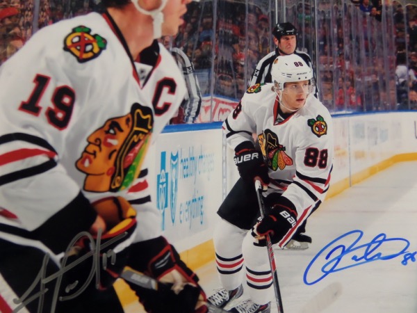 This full color 8x10 photo is affixed to a white posterboard backing that measures 8x11.  It is a color action image of the two Chicago Blackhawks stars, and it comes hand-signed by both, with Kane in blue sharpie and Toews in silver.  AWESOME Blackhawks item from a very successful era, and retail is mid hundreds!