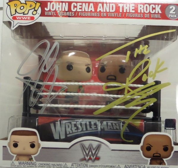 This amazing collectible is a new, boxed and sealed 2-pack of Funkos, and shows both the Rock and John Cena inside the ring. Super cool look, gold paint pen signed by BOTH on the outside packaging, and grade is a clean bold 10 all over. High value with the Hollywood Star Dwayne Johnson appearing, and Cena's no easy task either. 