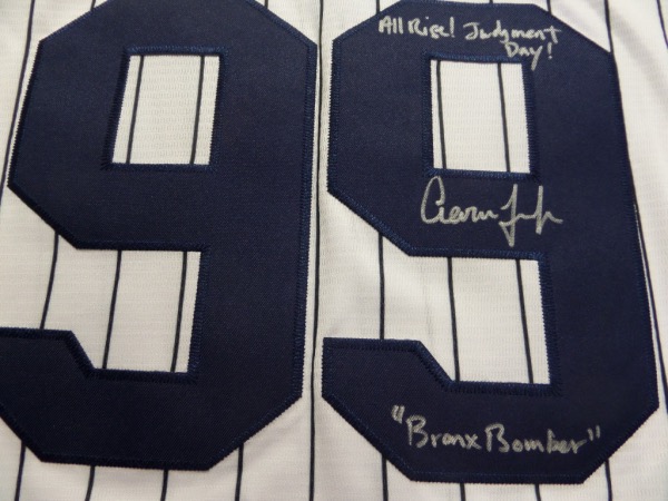 This home white, pinstriped size 44 Yanks jersey from Nike is tagged as new, and comes trimmed in navy, with everything sewn.  It is back number-signed in silver by the All Star outfielder himself, grading an overall 8.5, with Judgement Day! Bronx Bomber, and All Rise!  inscriptions.  A MUST for the true Yankee collector, and retail is high hundreds!