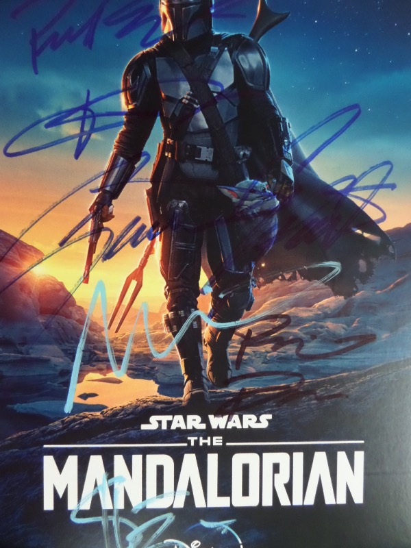 Well, Baby Yoda didn't sign this one, but that doesn't make this baby any less desirable.  Star Wars collectors will want to get in on this full color 8.5x11 "The Mandalorian" publicity promo photo print.  It is hand-signed by 7 stars of the series, including Pedro Pascal, Giancarlo Esposito, Rosario Dawson, Taika Waititi, Clancy Brown, Sasha Banks, and one other.  AWESOME Star Wars collectible, and retail is mid/high hundreds!