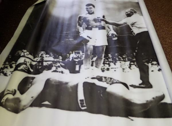 This original painting is on real canvas, measures 6x8 FEET in size, and shows Ali knocking out Sonny Liston in 1964. It is a dyed inked linseen oil that comes out of JB Studios. It hung ovr a training ring for years where boxers and MMA fighters trained for the Bellatore. Value is thousands, and there is only ONE in the world!