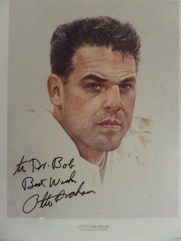 This roughly 10x13 full color litho print is an image of Browns HOF QB, Otto Graham.  It is hand-signed in black sharpie by the man himself, grading a legible 9, and personalized to Dr. Bob w/ Best Wishes added.  Comes with a COA and hologram from The Memorabilia Network (A003248) for authenticity purposes.  Valued well into the hundreds from this deceased all time great!