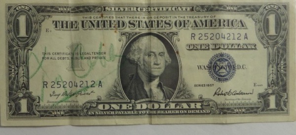 This vintage Series 1957 A United States Silver Certificate $1.00 bill is still in VG shape overall, and comes hand signed in green by lifetime .367 hitter and 1936 original HOF Inductee, Ty Cobb.  The signature grades about a 5, but will still be seen from 7-10 feet away, and with Cobb's death now more than 60 years ago, retail is low thousands!