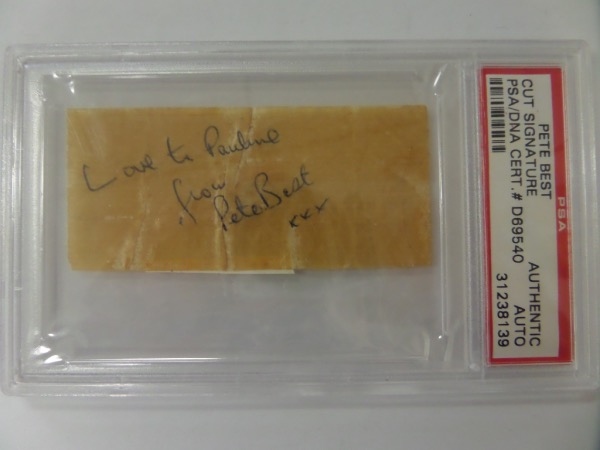 No Beatles collection would be complete without this rare gem!  It is a very old cut of paper, measuring approximately 1.5x3.5, and slabbed authentic by PSA (D69540).  The cut is toned to an almost brown color, comes hand-signed in ink by Best, is personalized with Love to Pauline, and will look fantastic when framed with the signatures/photos of your choice.  A one of a kind item here!
