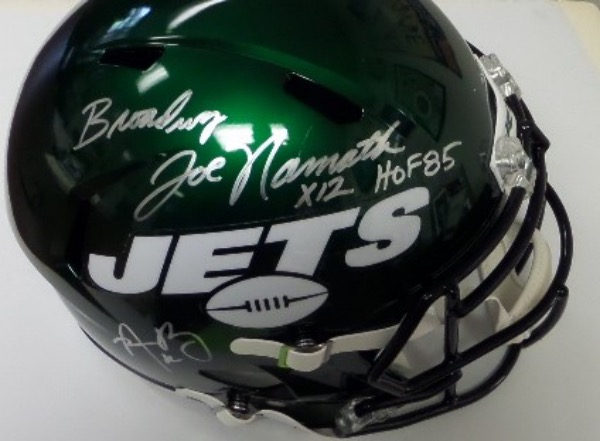 This full size New York Jets football helmet from Riddell is a replica style helmet that comes to us in NM condition.  It is hand-signed in bright silver by legendary Jets QB Joe Namath, reading Broadway Joe Namath, with X12 and HOF85 inscriptions, but that's not all.  It is also penned in silver by brand NEW Jets QB and future HOF'er Aaron Rodgers.  Signatures look fabulous on this awesome helmet, and retail is low thousands!