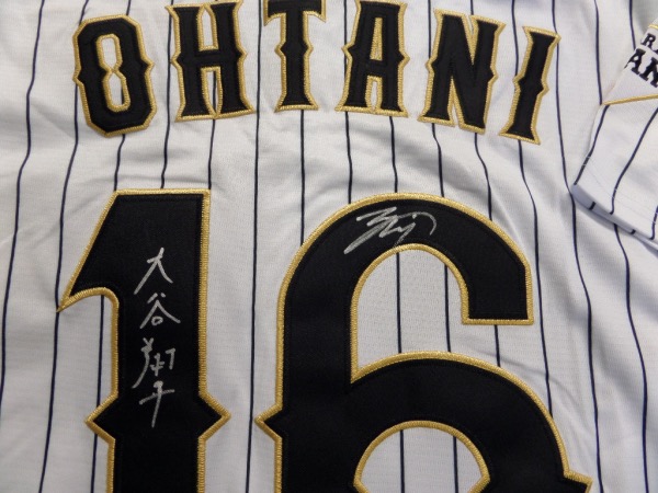 This white size L custom #16 Japan Ohtani jersey is in NEW condition, with everything hand-sewn.  It is back number-signed in bright silver by the 2021 AL MVP himself, written in both English and Japanese, grading an 8 at least.  A great looking jersey, and retail is high hundreds right now at least!