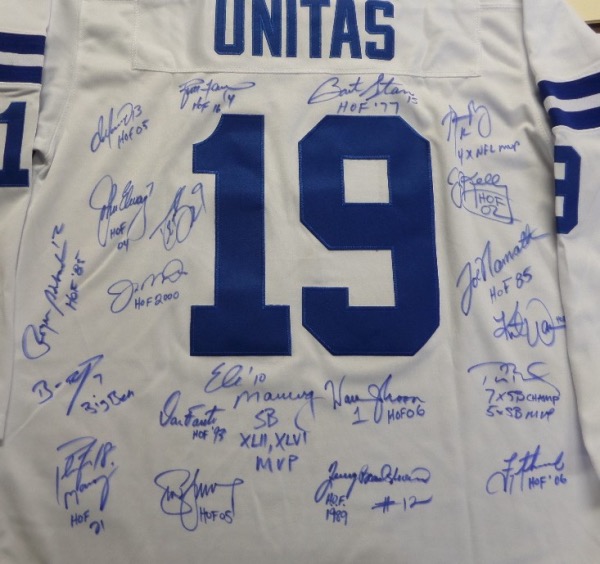 This white size 50 Johnny Unitas #19 throwback from Mitchell & Ness is still in NM condition, and has everything sewn.  It is back-signed in blue sharpie by 20 of the greatest quarterbacks to ever roam the gridiron, including Marino, Favre, Elway, Montana, Brees, Staubach, Roethlisberger, Manning, Fouts, Manning, Young, Moon, Bradshaw, Aikman, Brady, Warner, Namath, Kelly, Rodgers and Starr, with every last QB adding his own inscription.  A super cool display jersey and conversation piece, valued well into the thousands!